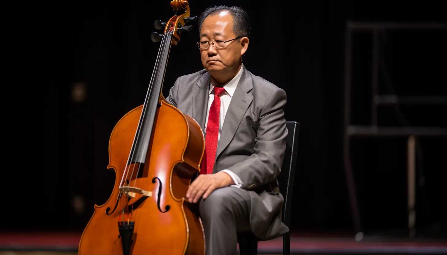 University President Santa Ono, holding a cello, in a deep thought, with a blurred background of an empty auditorium, taken with Sony Alpha a7 III