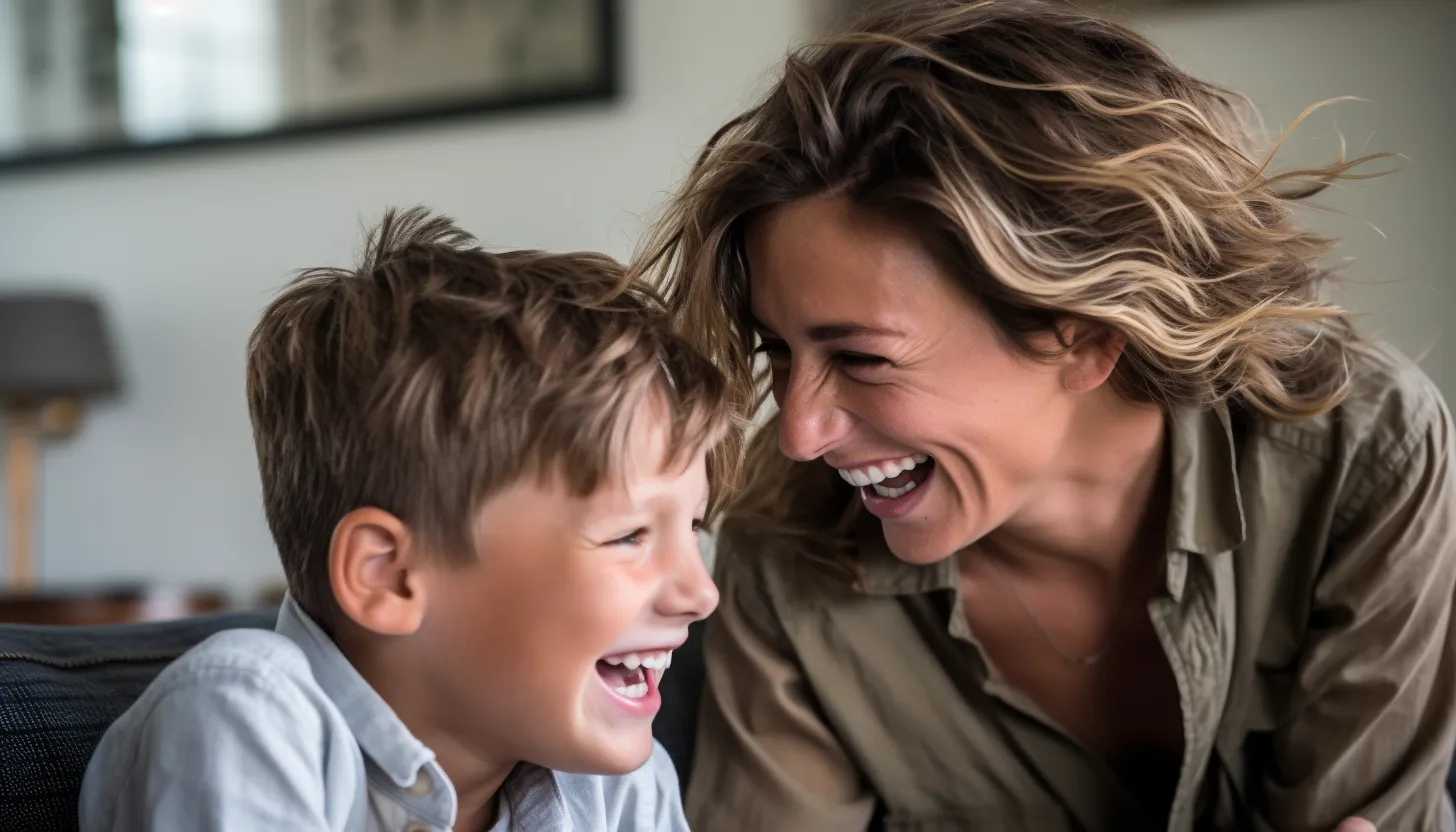 A touching image of a mother and son sharing a moment. They're in a living room, with the mother playfully ruffling her son's hair as they both laugh. Their bond is palpable and the atmosphere is light-hearted, echoing the joy and sorrow of growing up. This image is taken with a Canon EOS 5D Mark IV.
